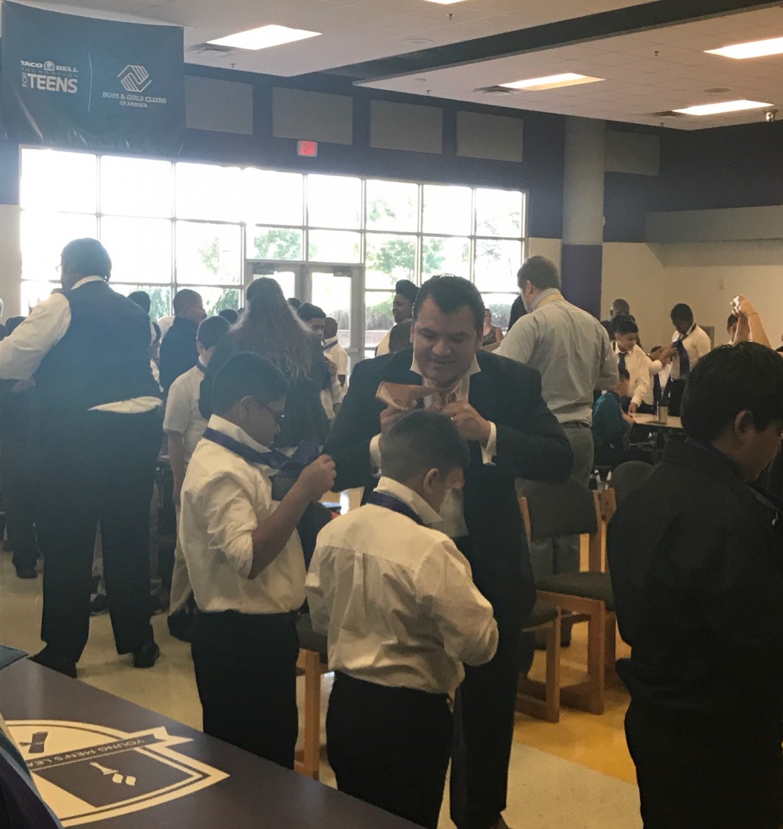 Dr Cruz teaches Garcia 6th graders how to tie their tie